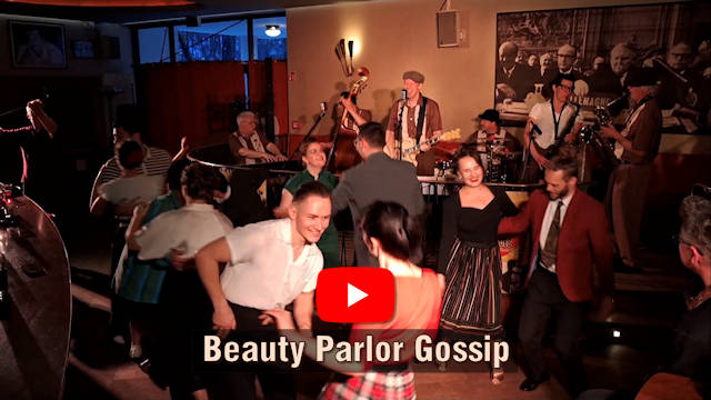 Man sieht Tänzer vor einer Bühne mit Band. Darunter steht der Songtitel "Beauty Parlor Gossip" mit dem YouTube Logo darüber.